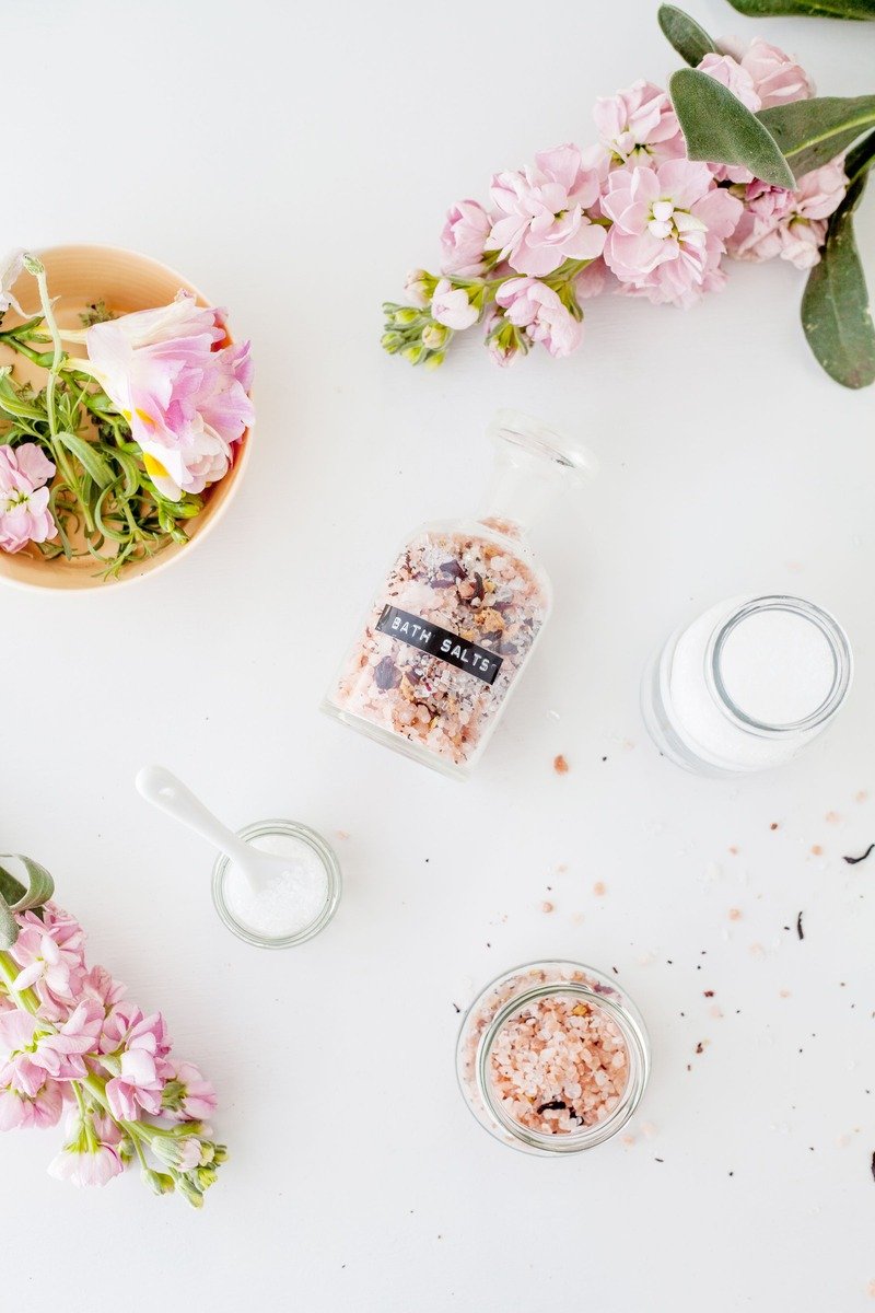 Jars of bath salts with flowers for a self care gift