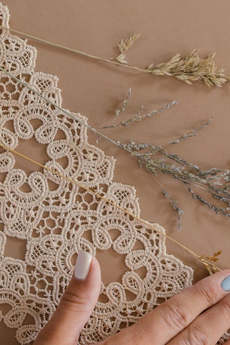 White nails with round doily-inspired lace mandala pattern