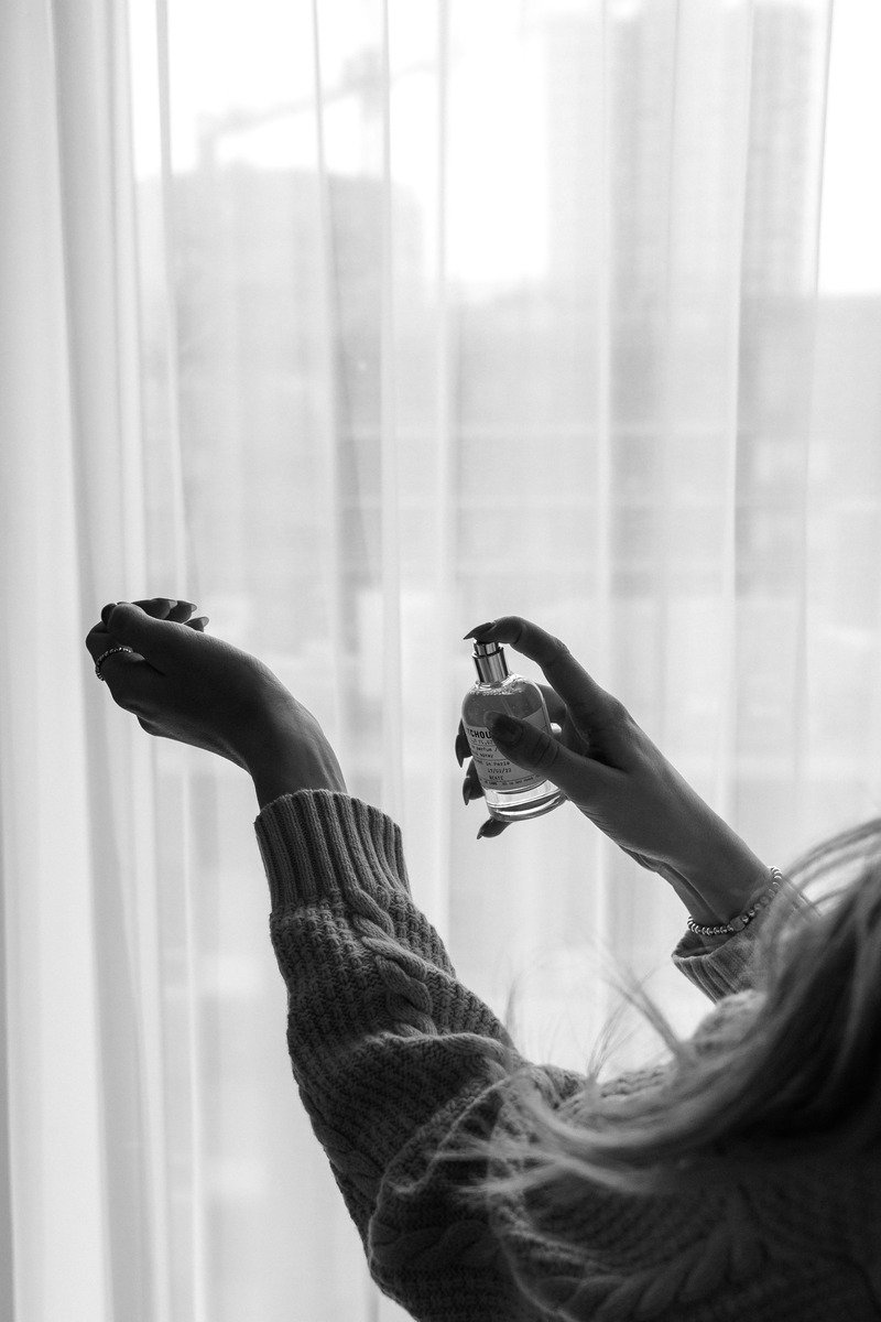 Woman spraying hair mist with flowing hair