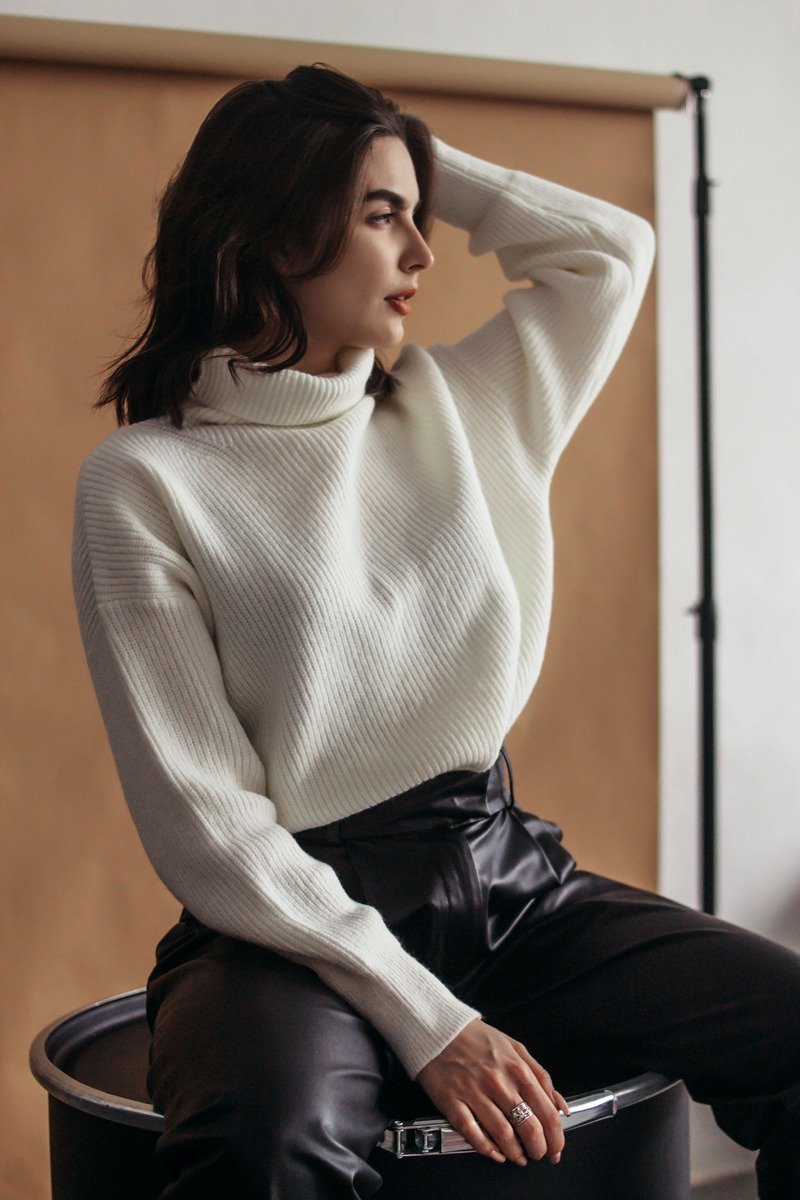 Woman over 40 in leather pants with a soft oversized sweater