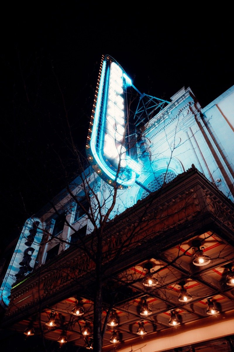 Historic theater marquee lit up at night in downtown Gainesville