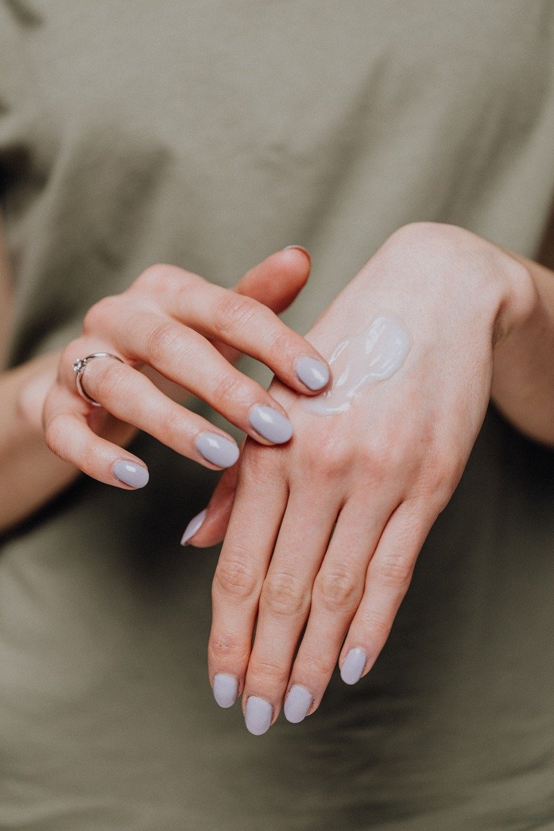 Applying cream to the backs of hands