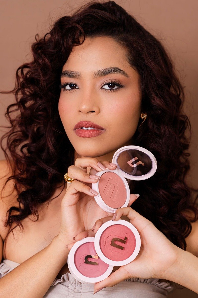 Rich dusty rose blush glowing on deep skin tone