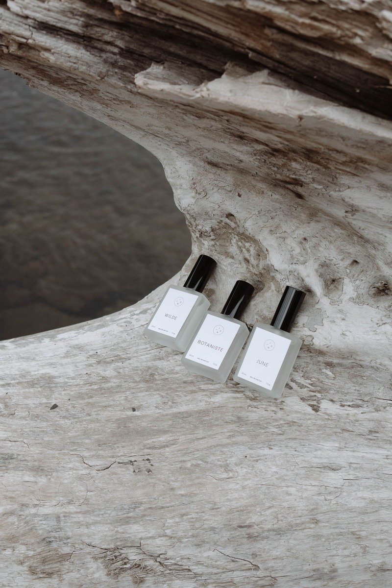 Two perfume bottles layered together on a tray
