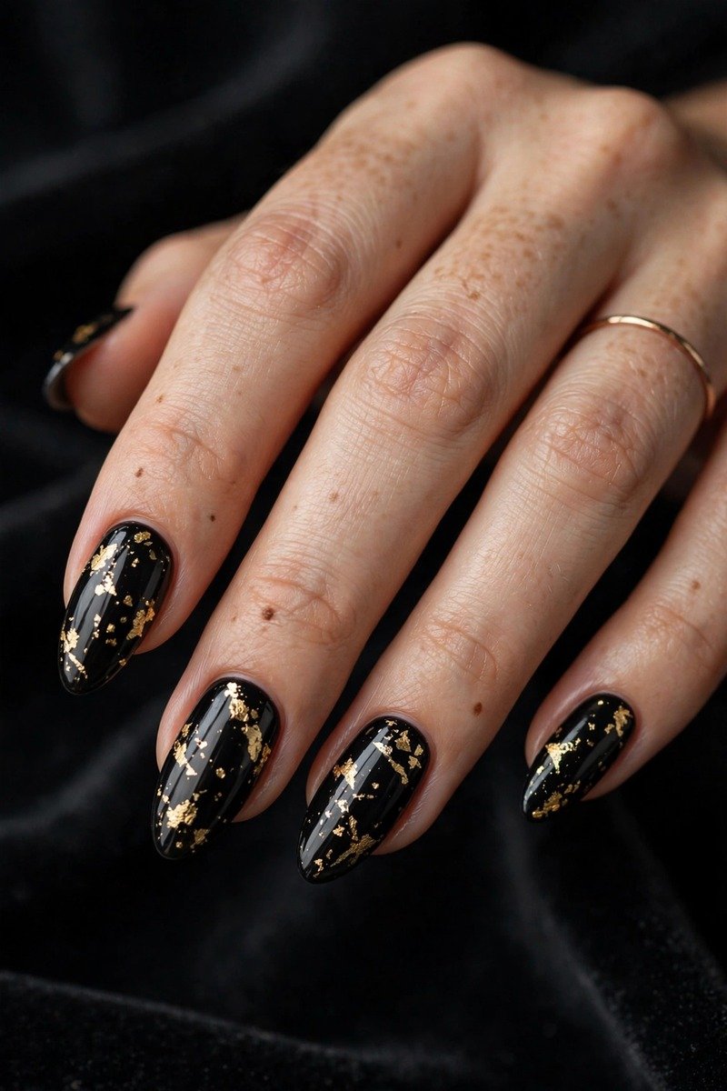 Black january nails with gold foil detail