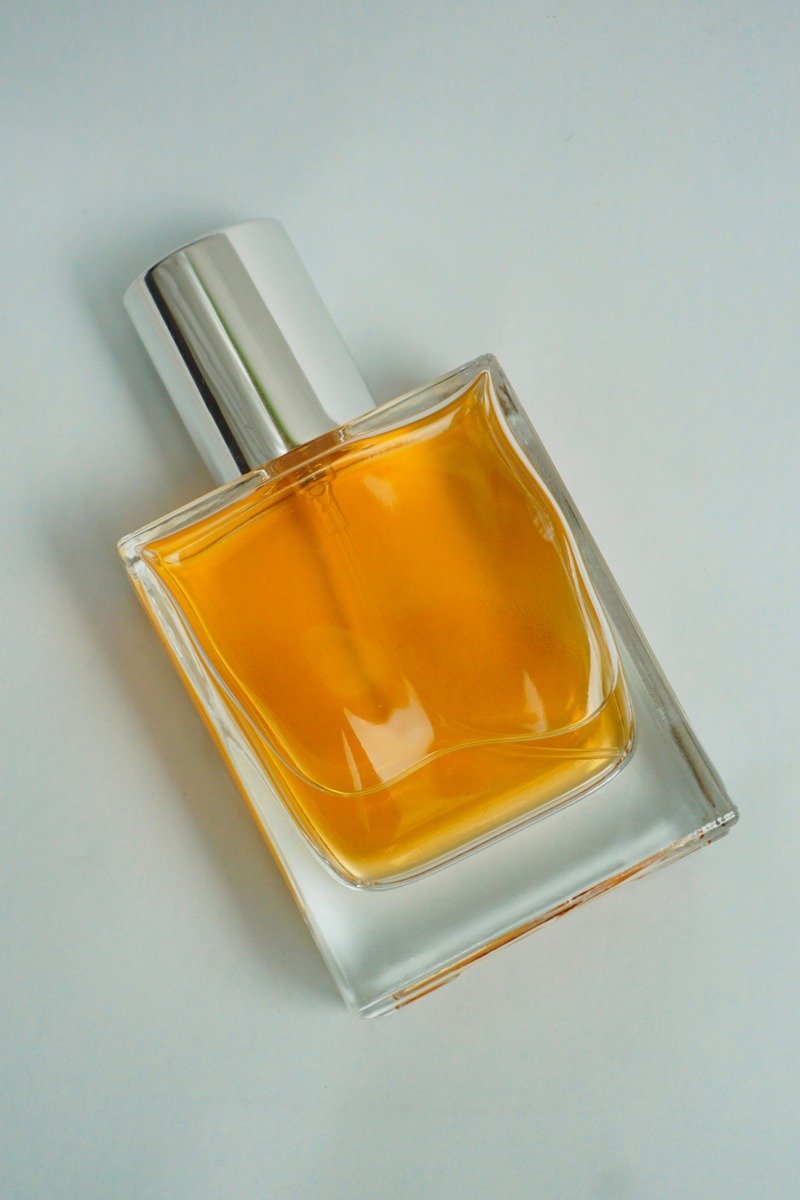 Warm amber perfume bottle with vanilla and cozy lighting