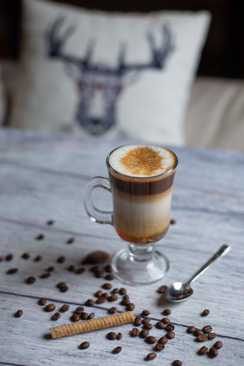Coffee beans with a wafer stick and a mug