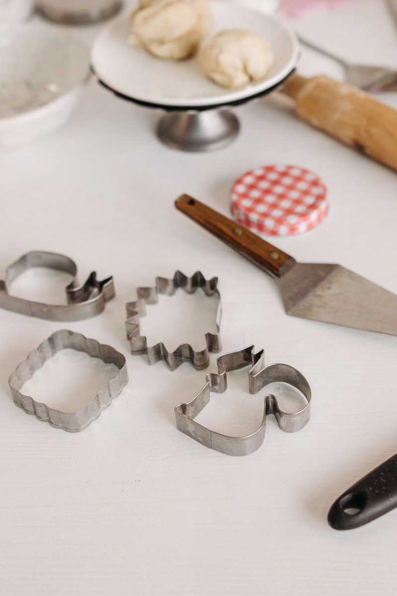 Cookie cutters and baking tools on a white table