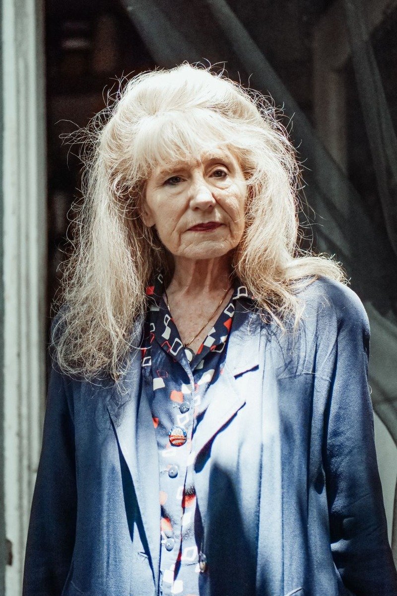 Woman over 50 in a blazer over a knit top