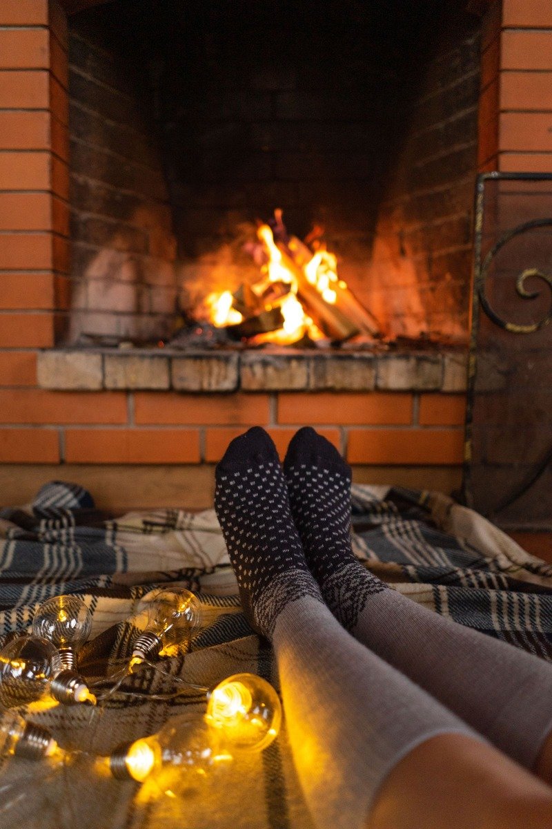Knitted wool socks by a fireplace