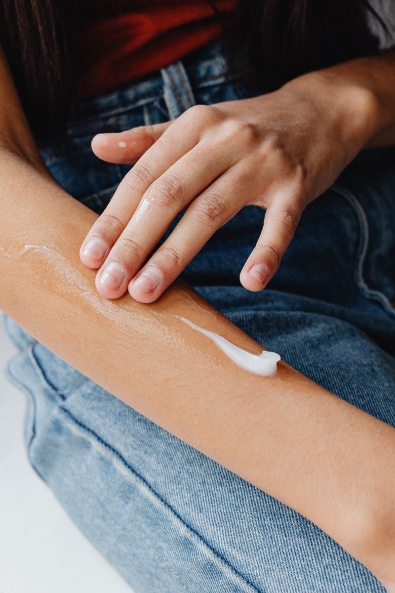 Retinol hand cream tube beside elegant hands