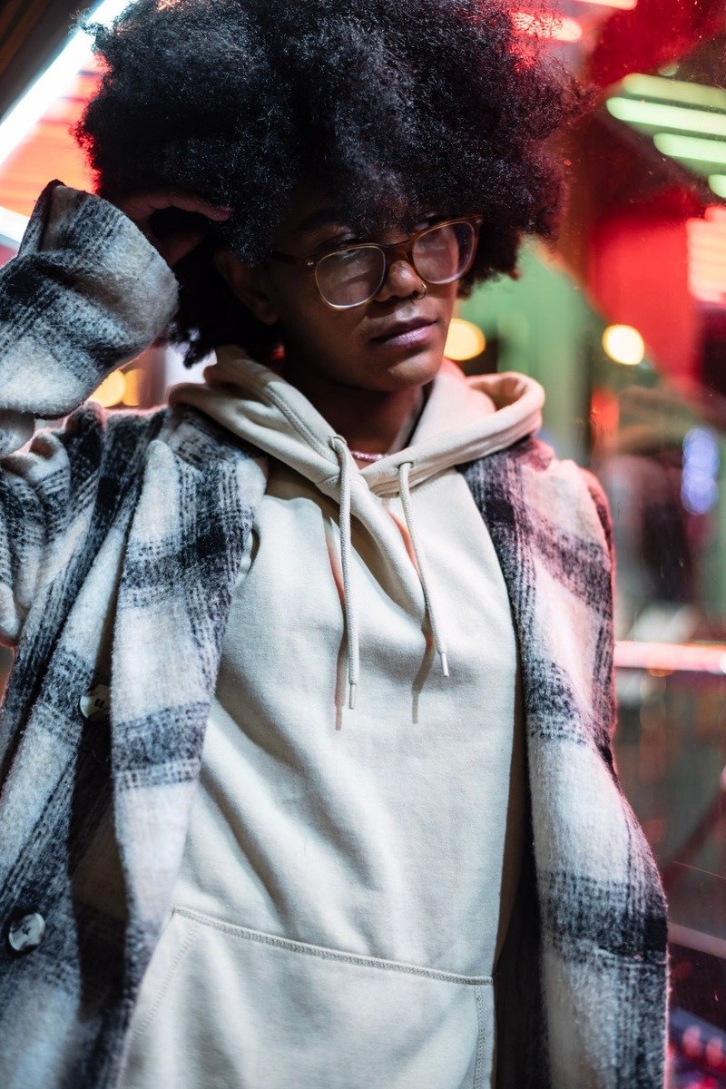 Woman in a hoodie under a long coat for a winter street look