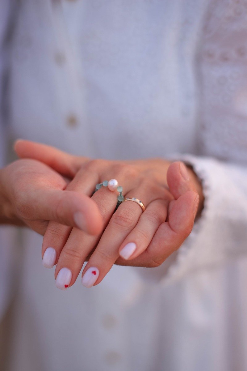 French manicure with one tiny heart on the ring finger