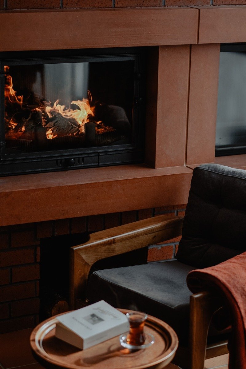Reading armchair beside a fireplace