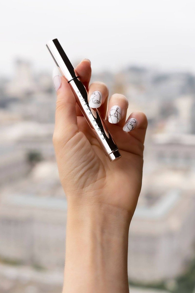 White nails with minimal black line art
