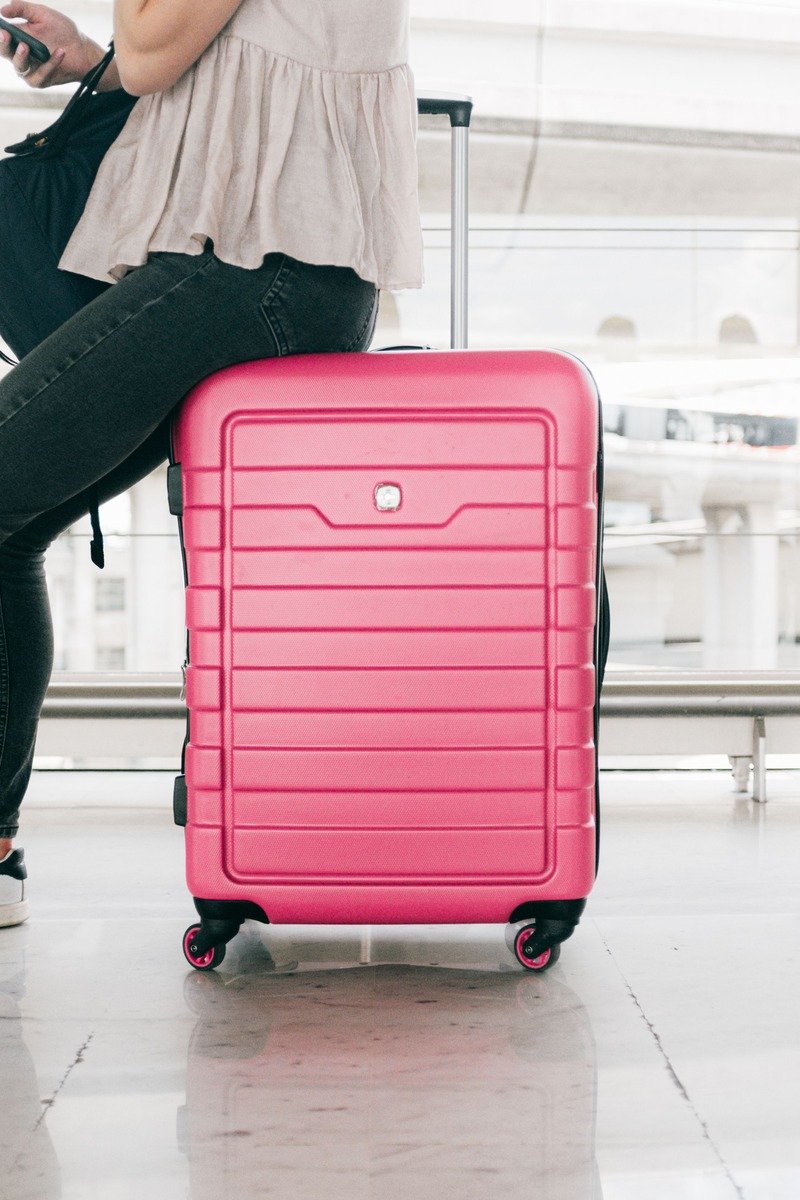Pink carry on suitcase at an airport