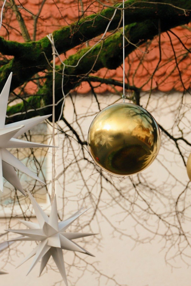 Gold ornaments and stars advent calendar on a branch