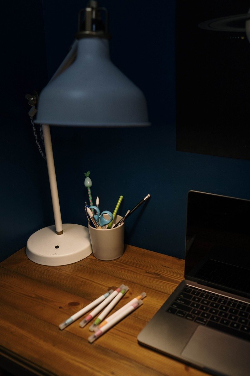 Desk lamp and stationery on a desk