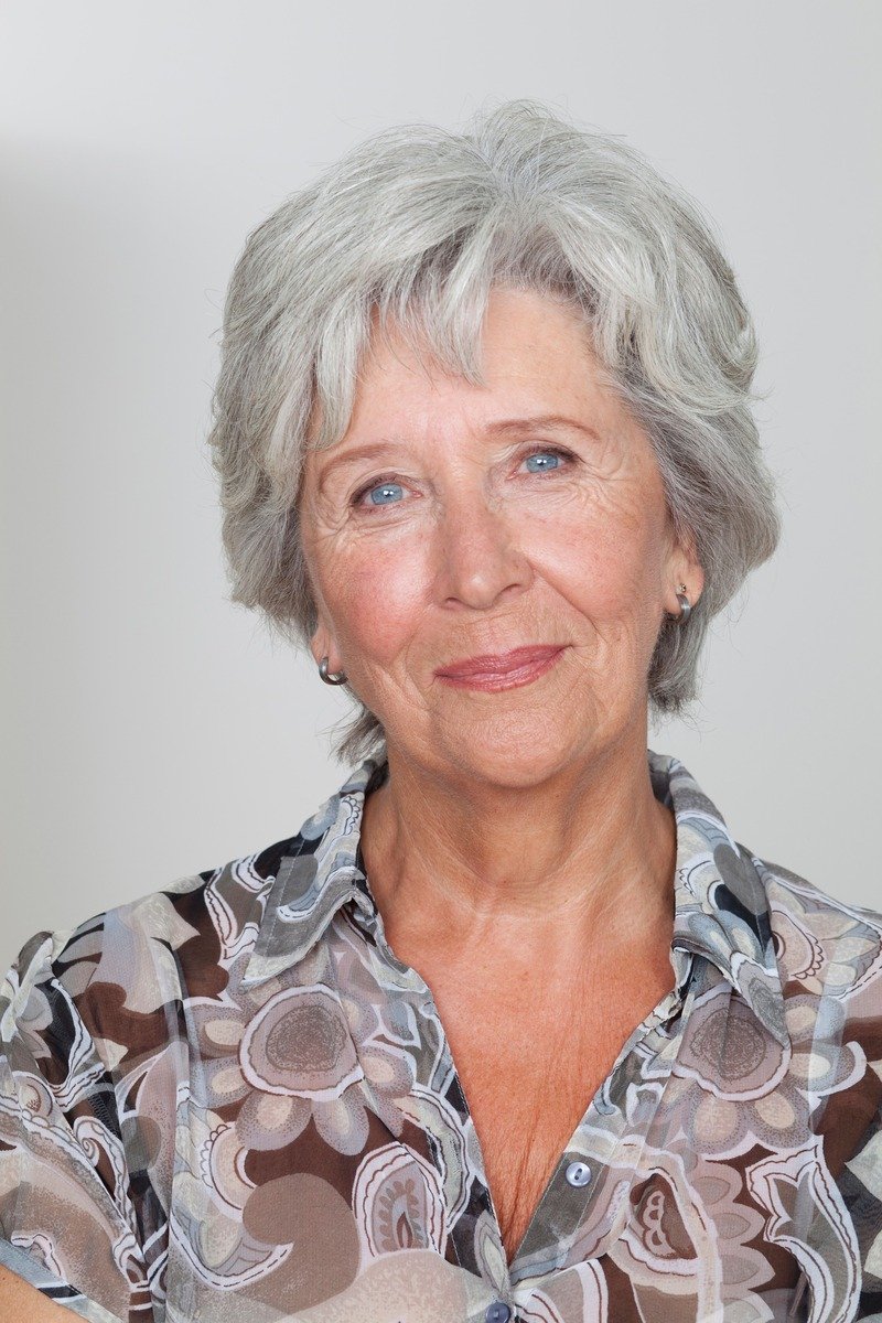 Woman over 50 with silver grey layered hair