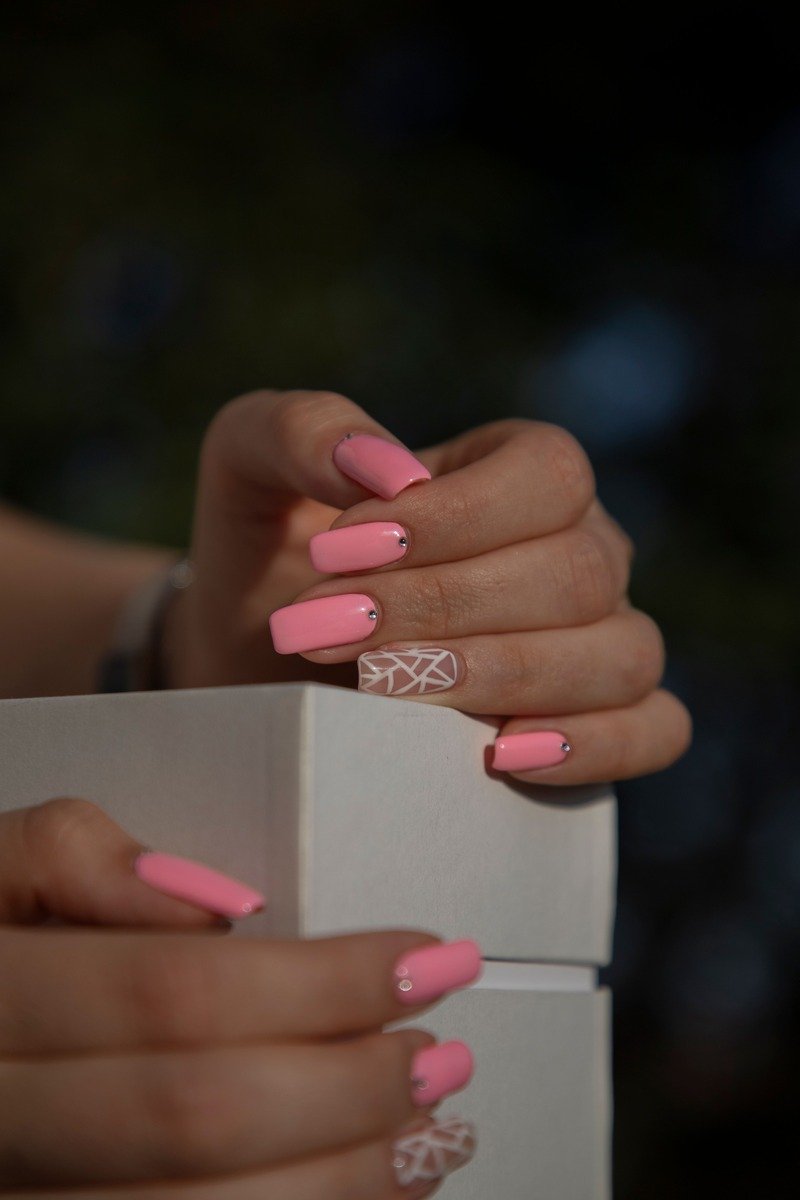 Pink january nails with a white lace accent nail