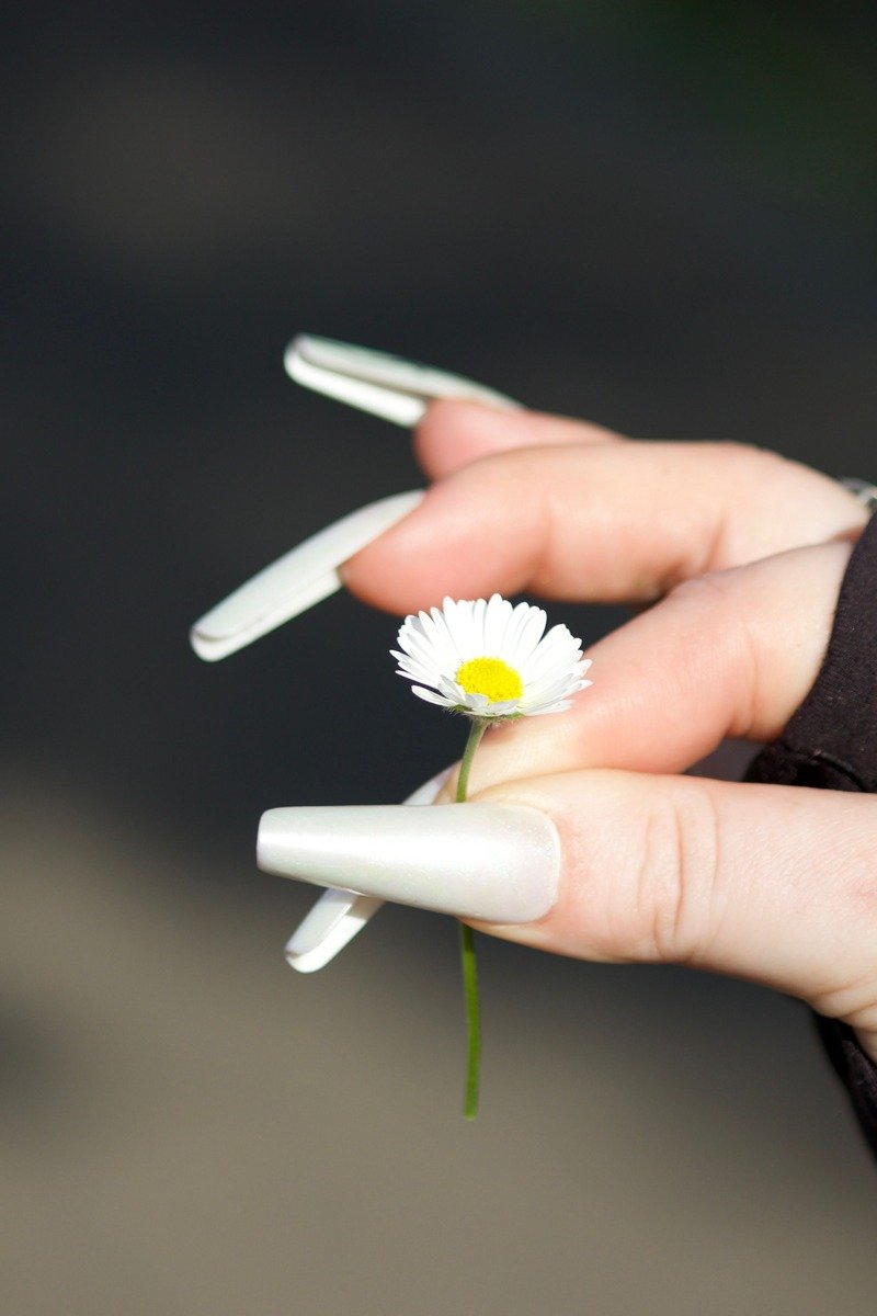 Long white january nails with pointed tips