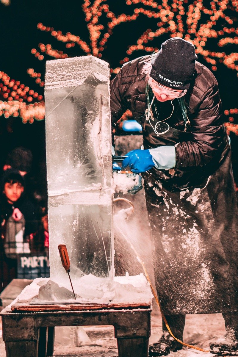 Sculptor carving ice at a winter festival