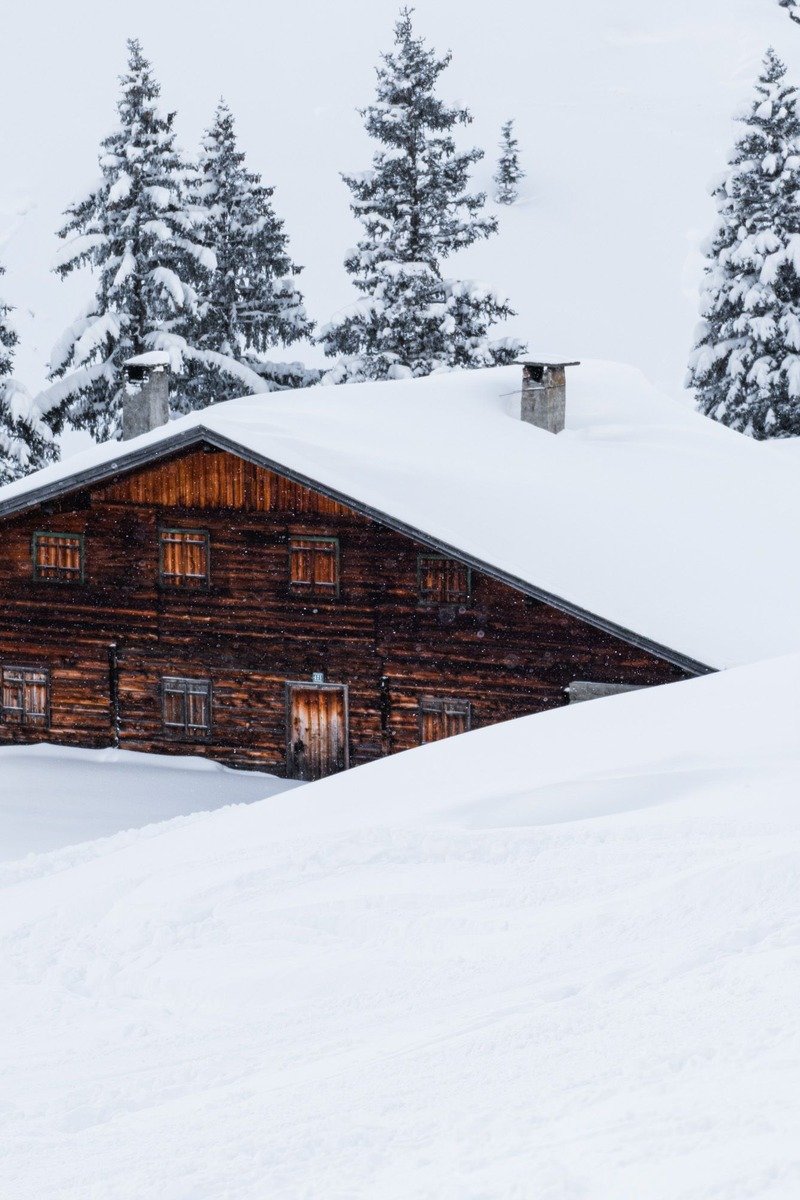 Cozy wooden cabin in deep snow