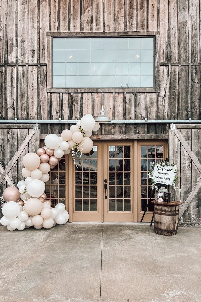 Balloon pillars flanking a party entrance door