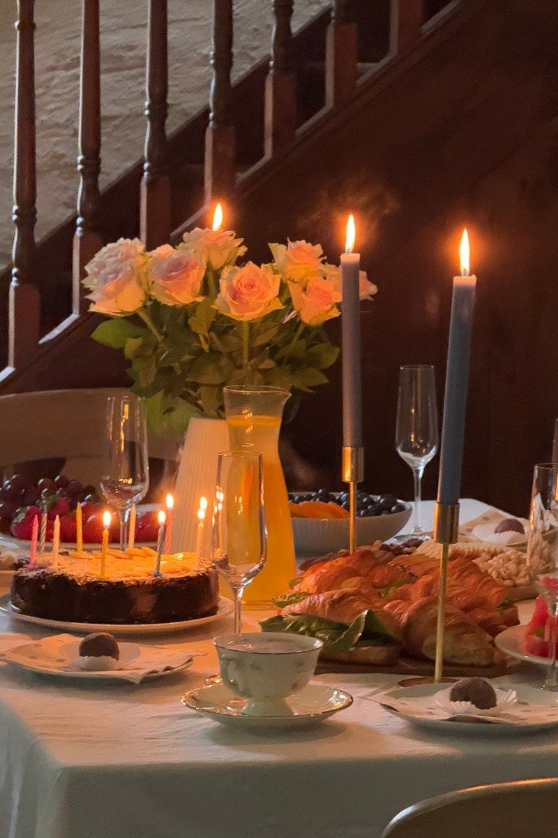 Birthday table with layered runners candles and flowers