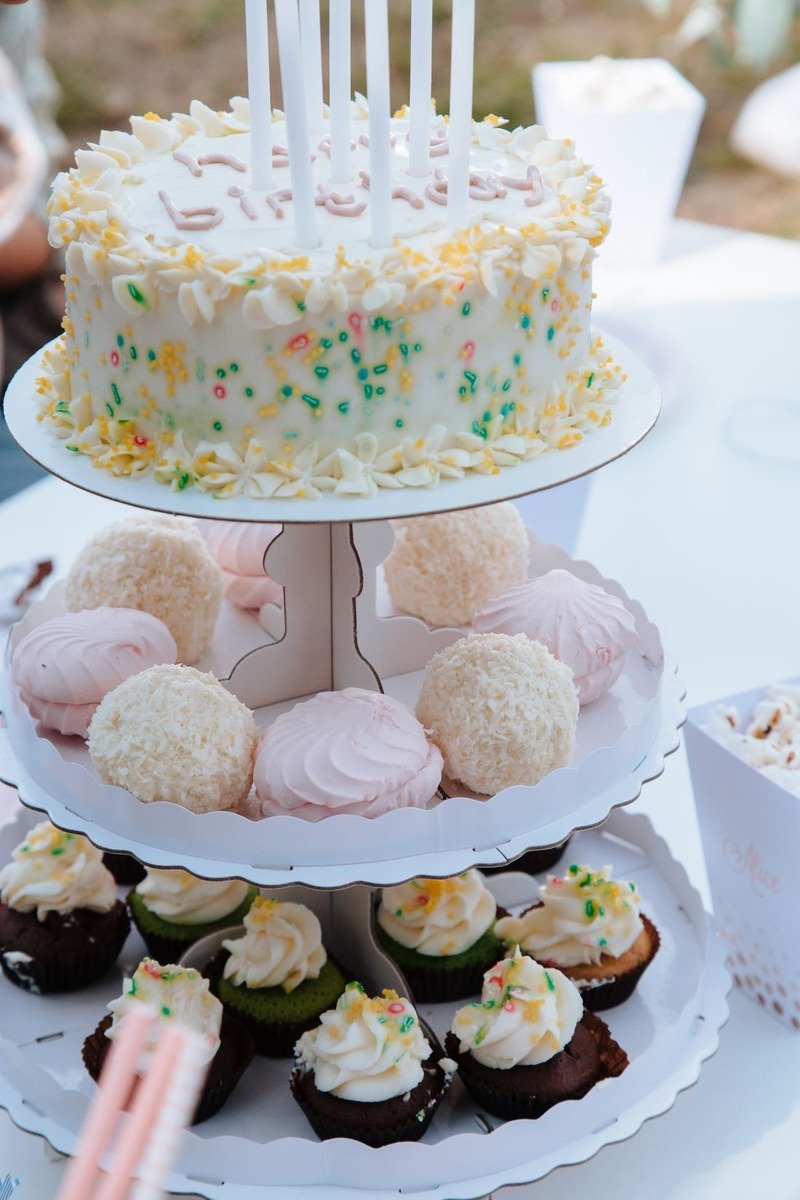 Tiered cake stands displaying birthday desserts