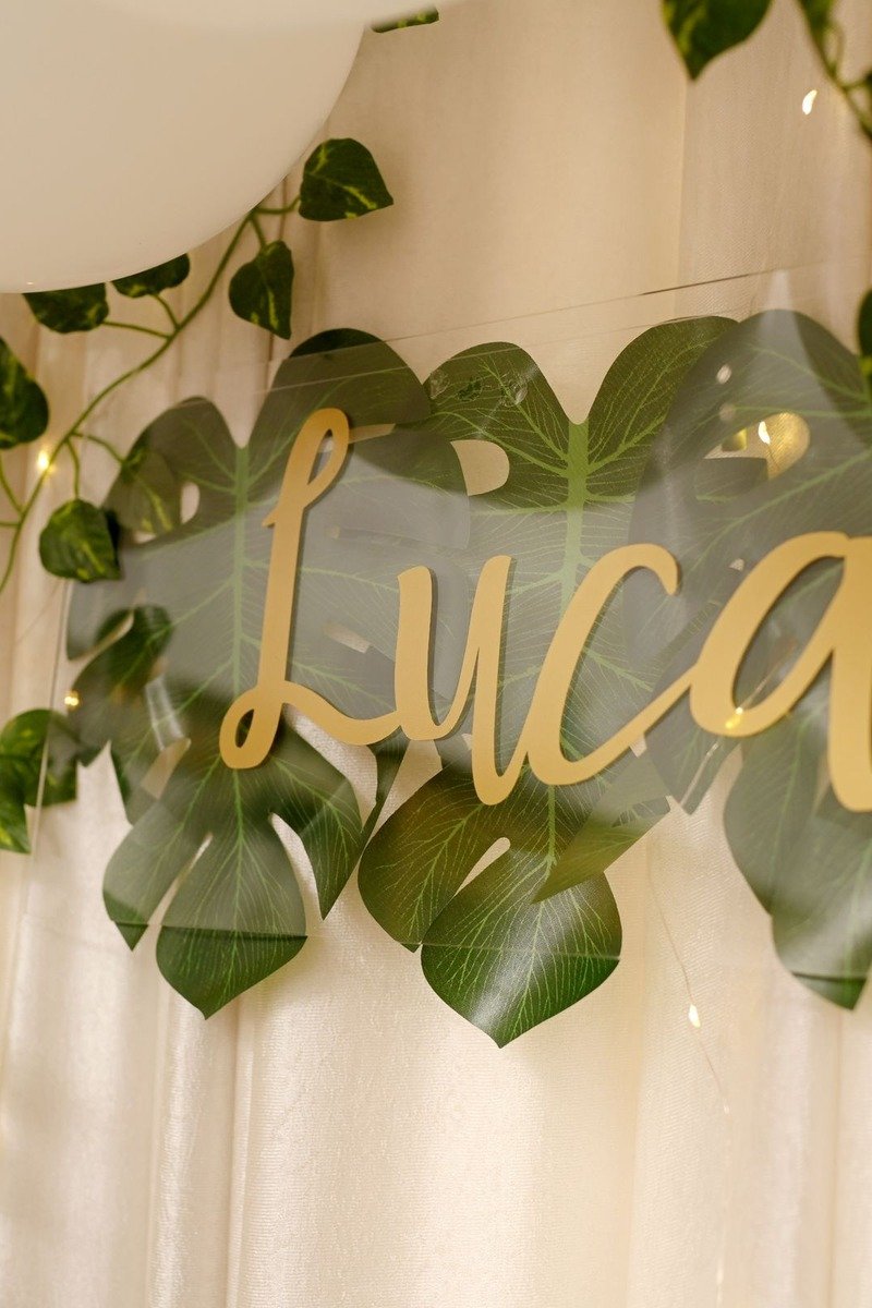 Personalized name banner hanging over a birthday table