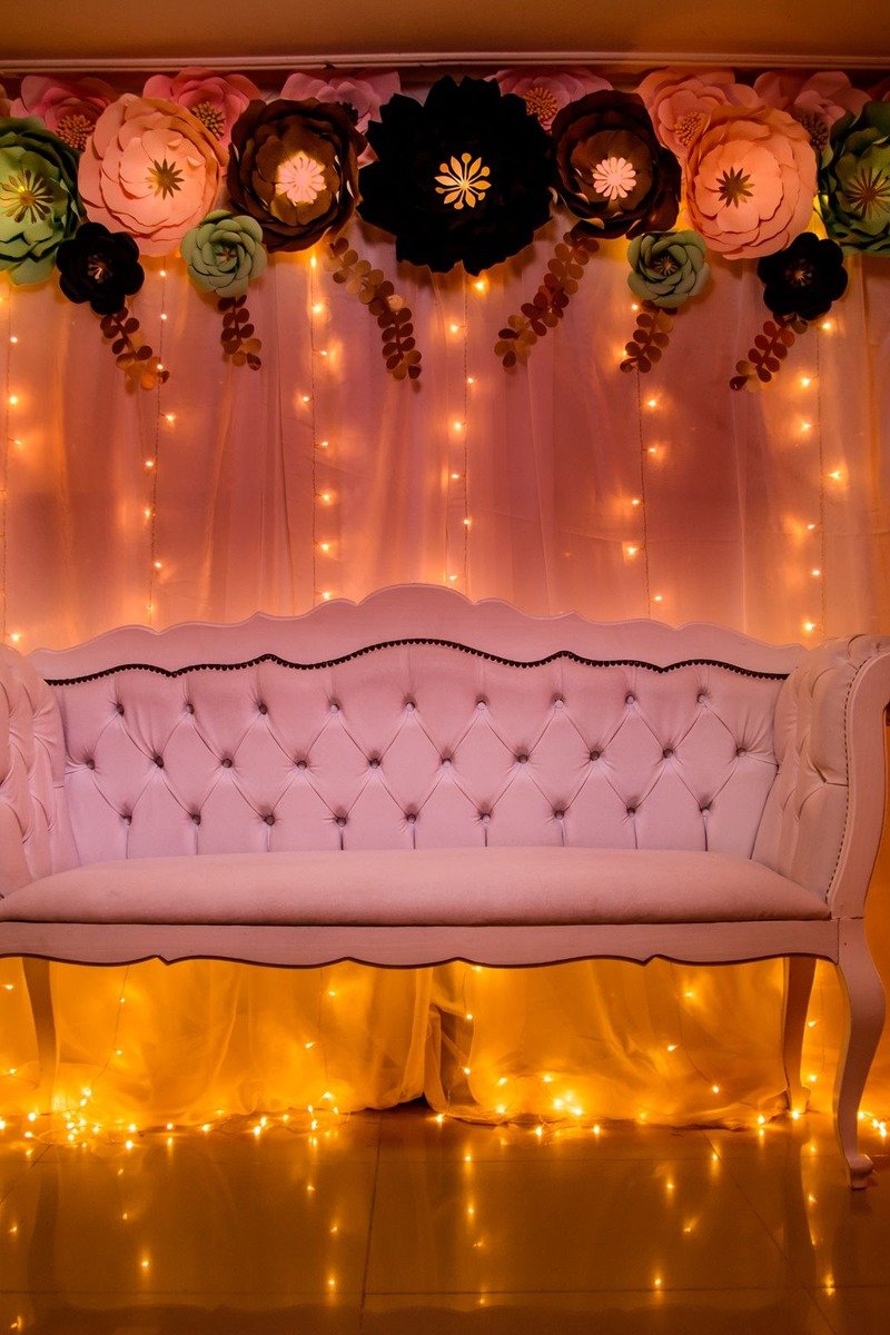 Fairy light curtain glowing behind a birthday cake table