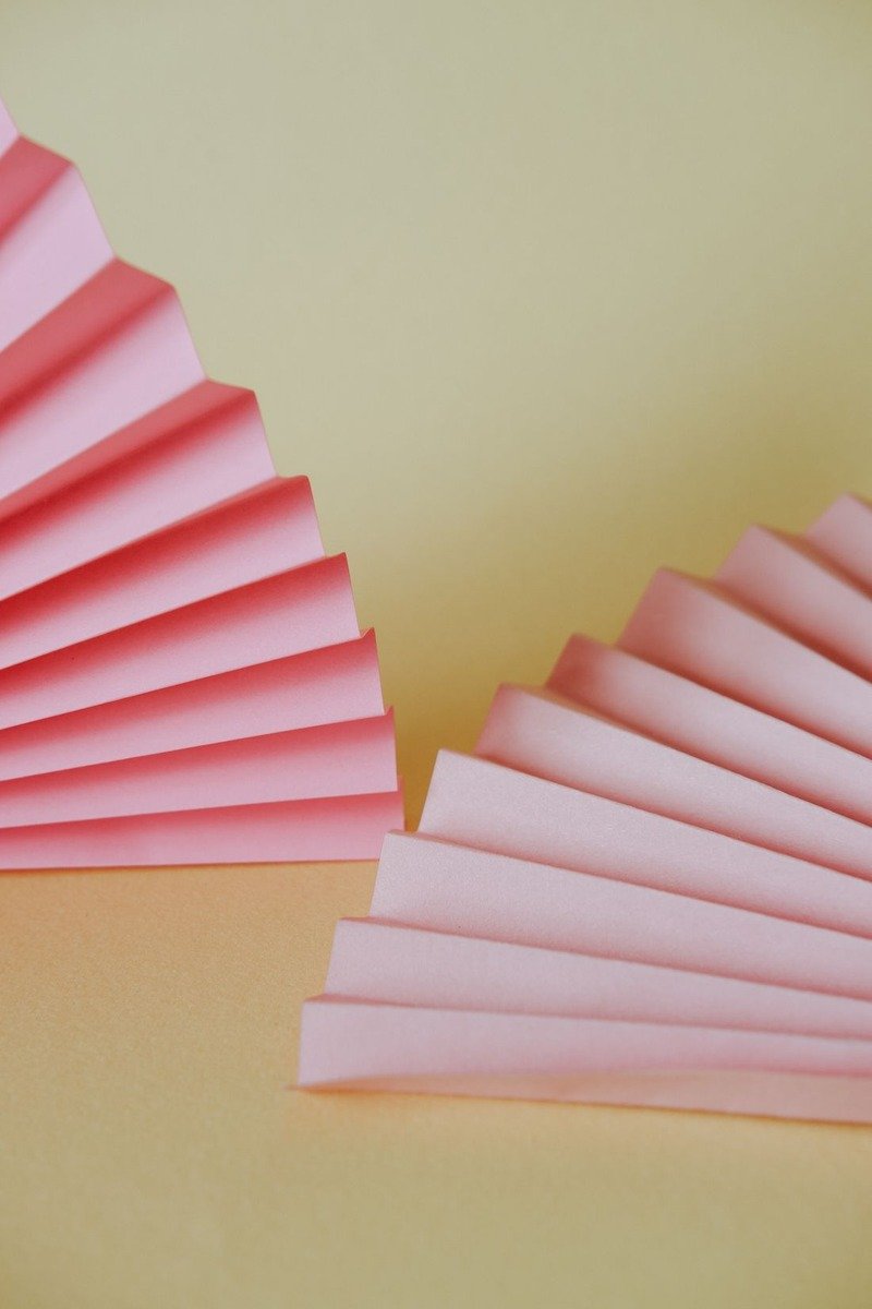 Paper fan rosettes arranged as a birthday backdrop wall