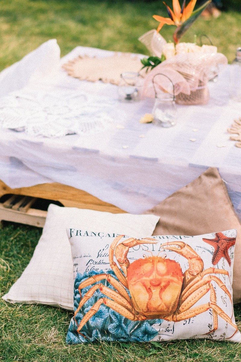 Garden picnic birthday setup with cushions and low tables