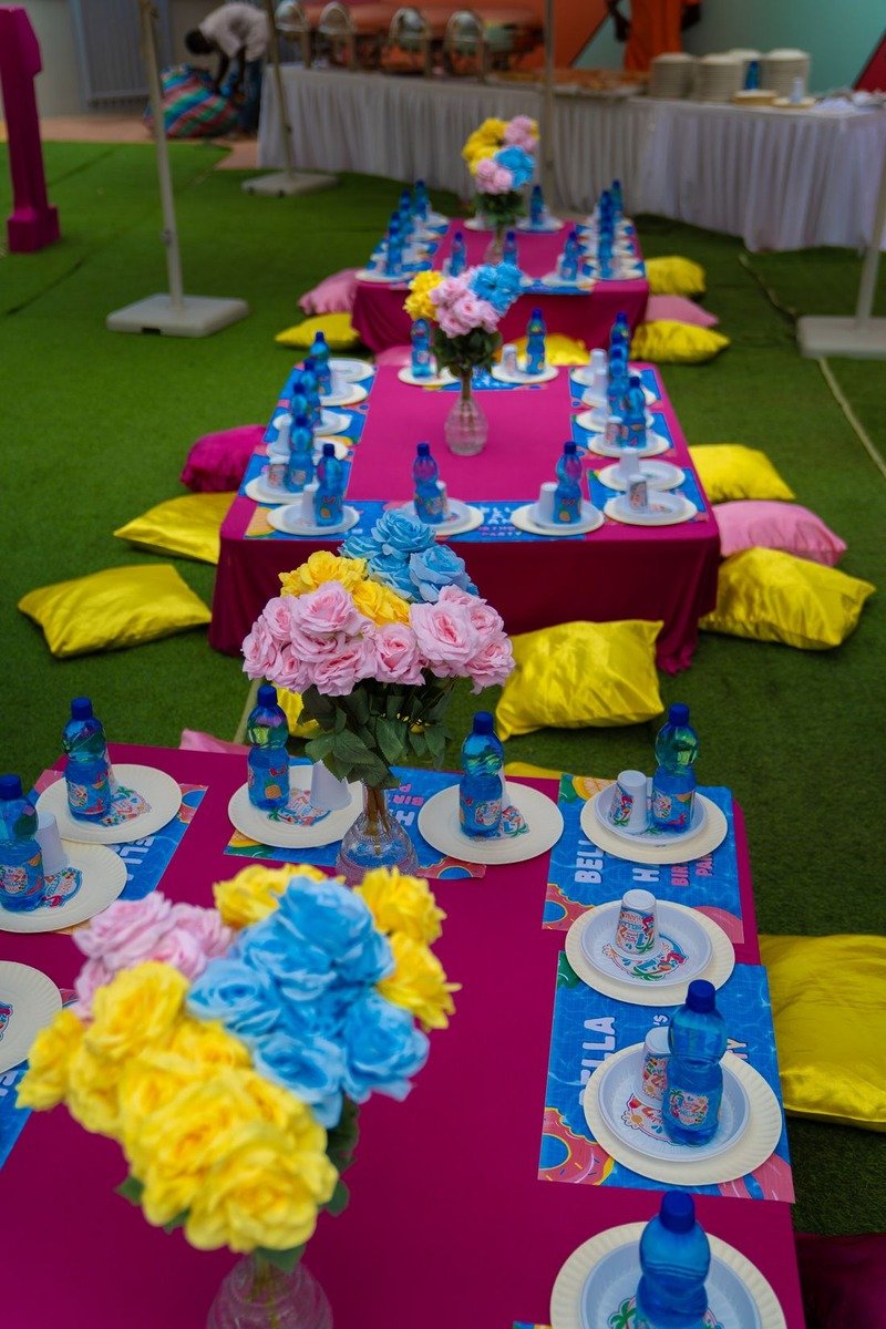 Low picnic table with birthday decorations on a lawn